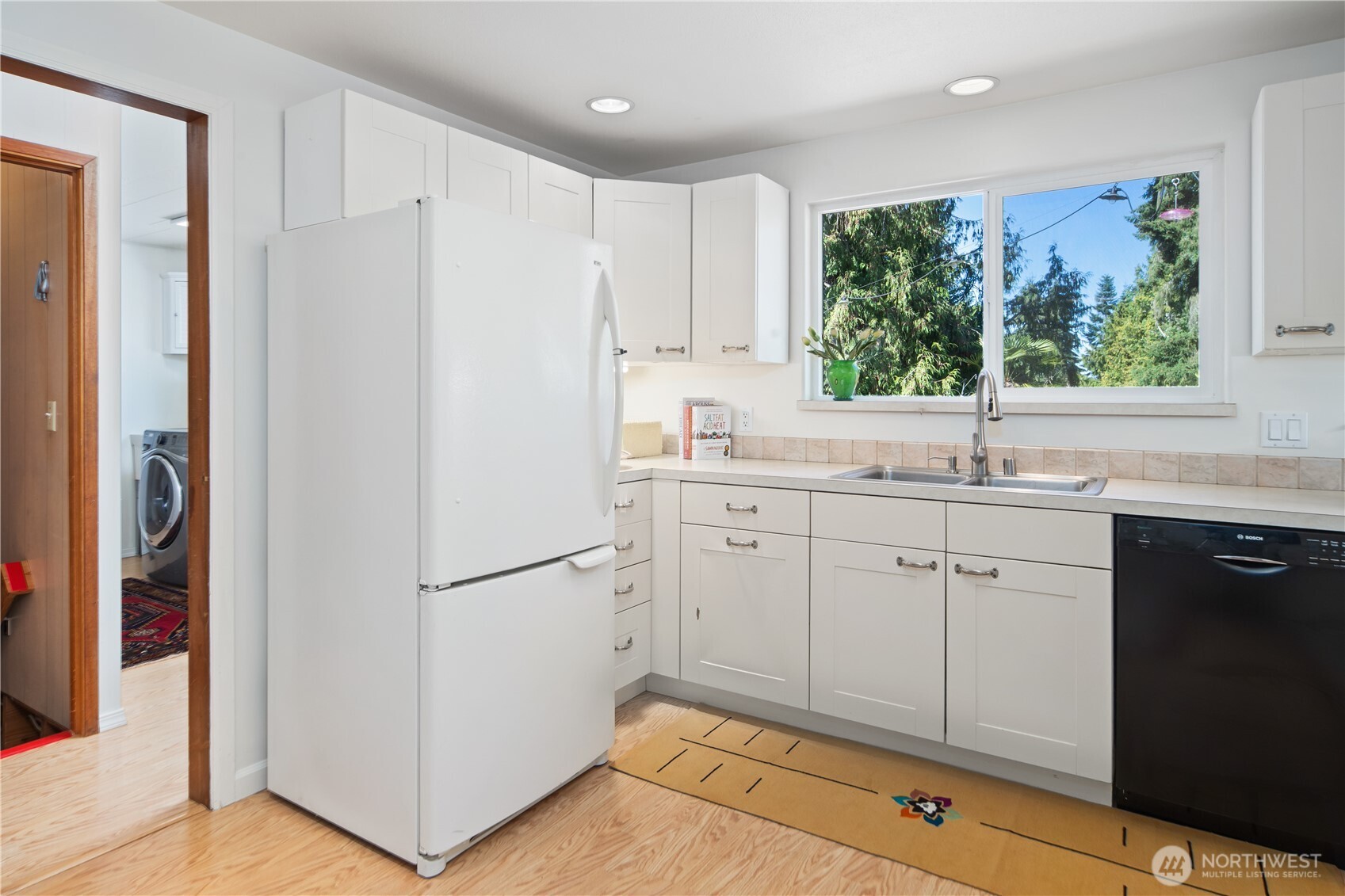 245 Gupster Road Sequim, WA 98382 - Photo 12 of 40 a kitchen with a refrigerator sink and cabinets
