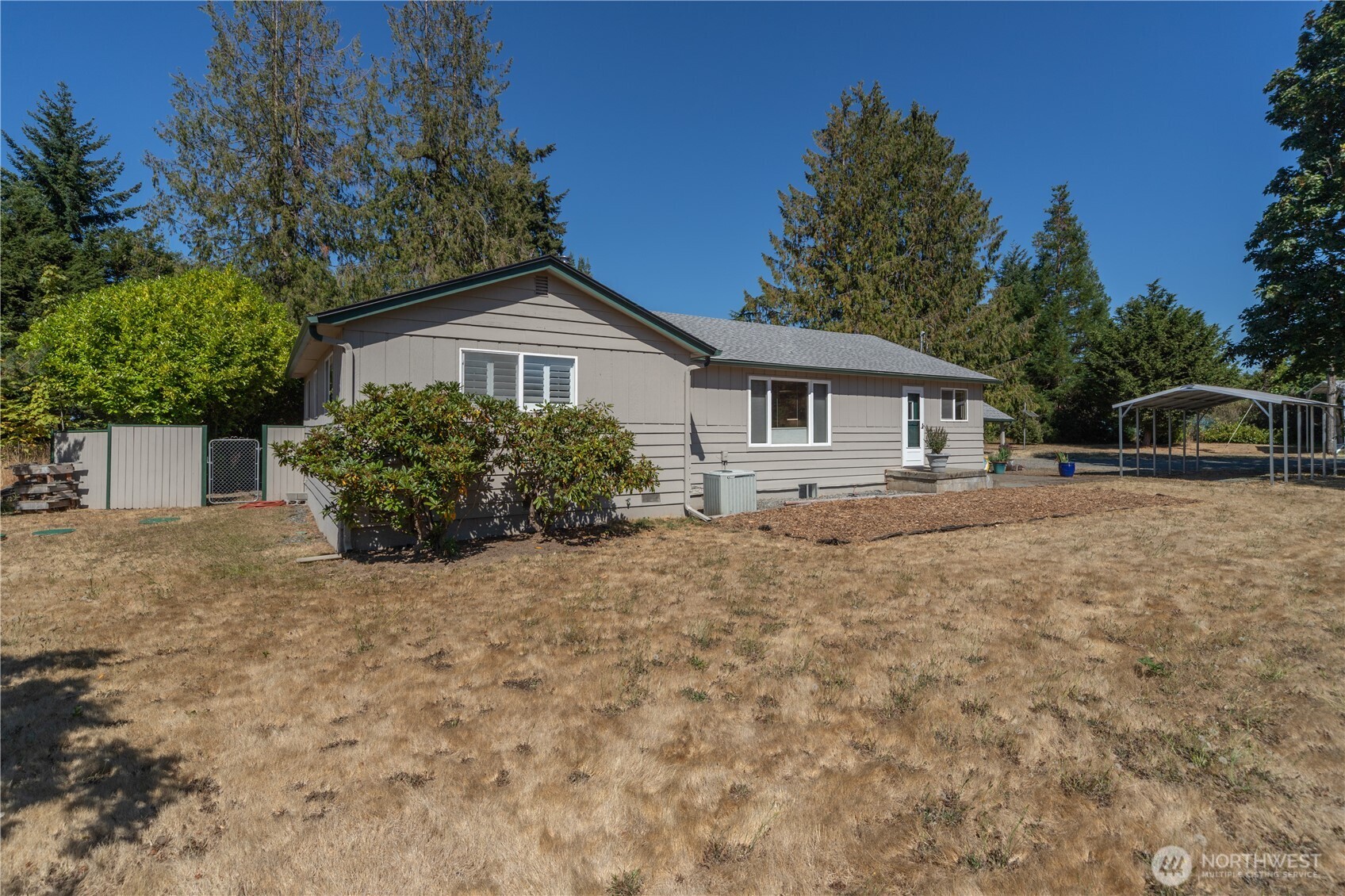 245 Gupster Road Sequim, WA 98382 - Photo 3 of 40 a house with trees in the background