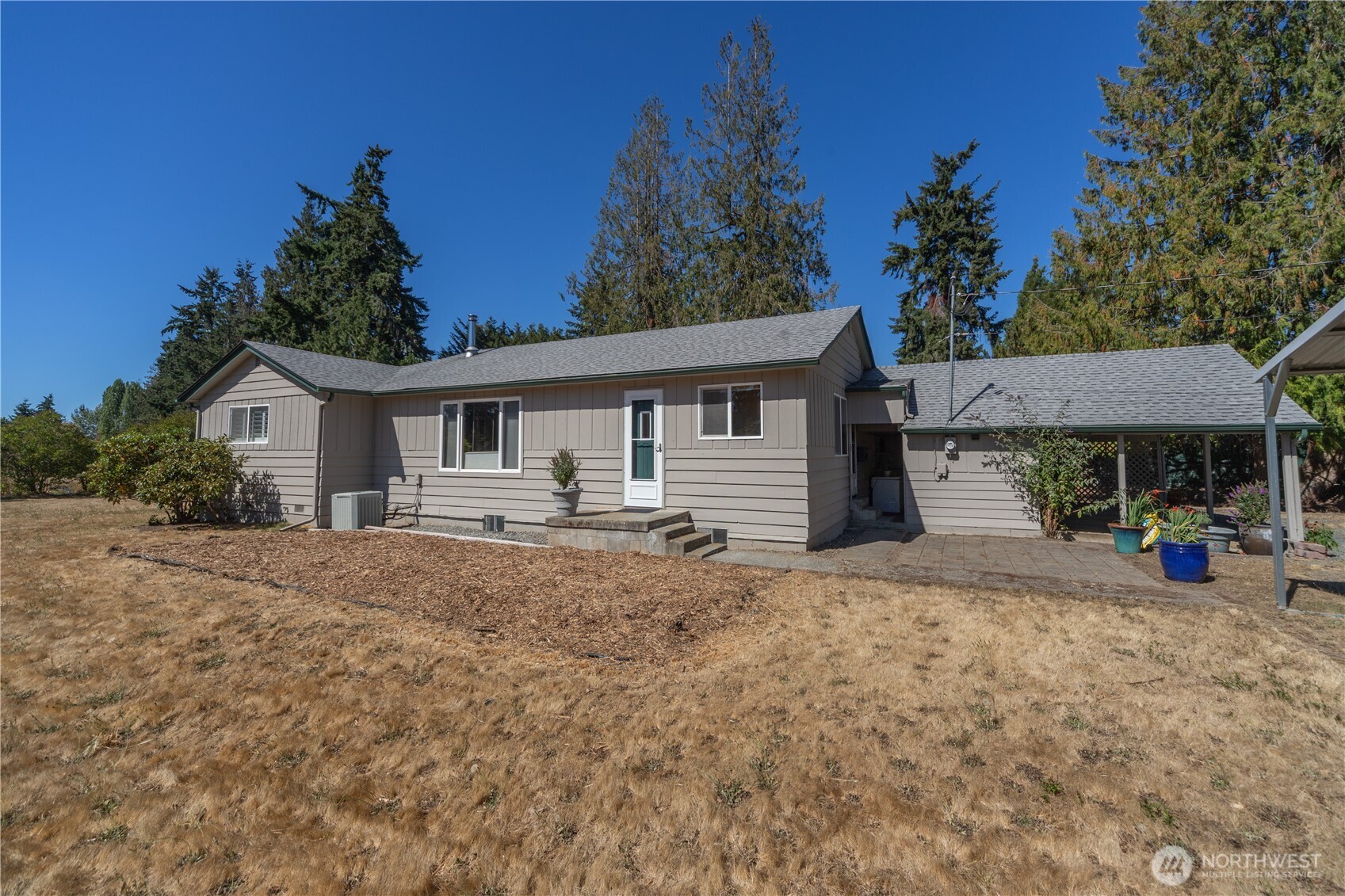245 Gupster Road Sequim, WA 98382 - Photo 4 of 40 a front view of a house with garage