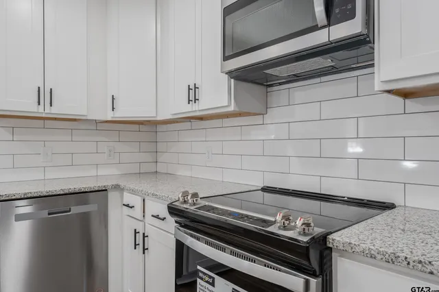 a stove top oven sitting inside of a kitchen