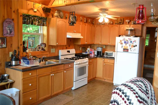 a kitchen with a sink appliances and cabinets