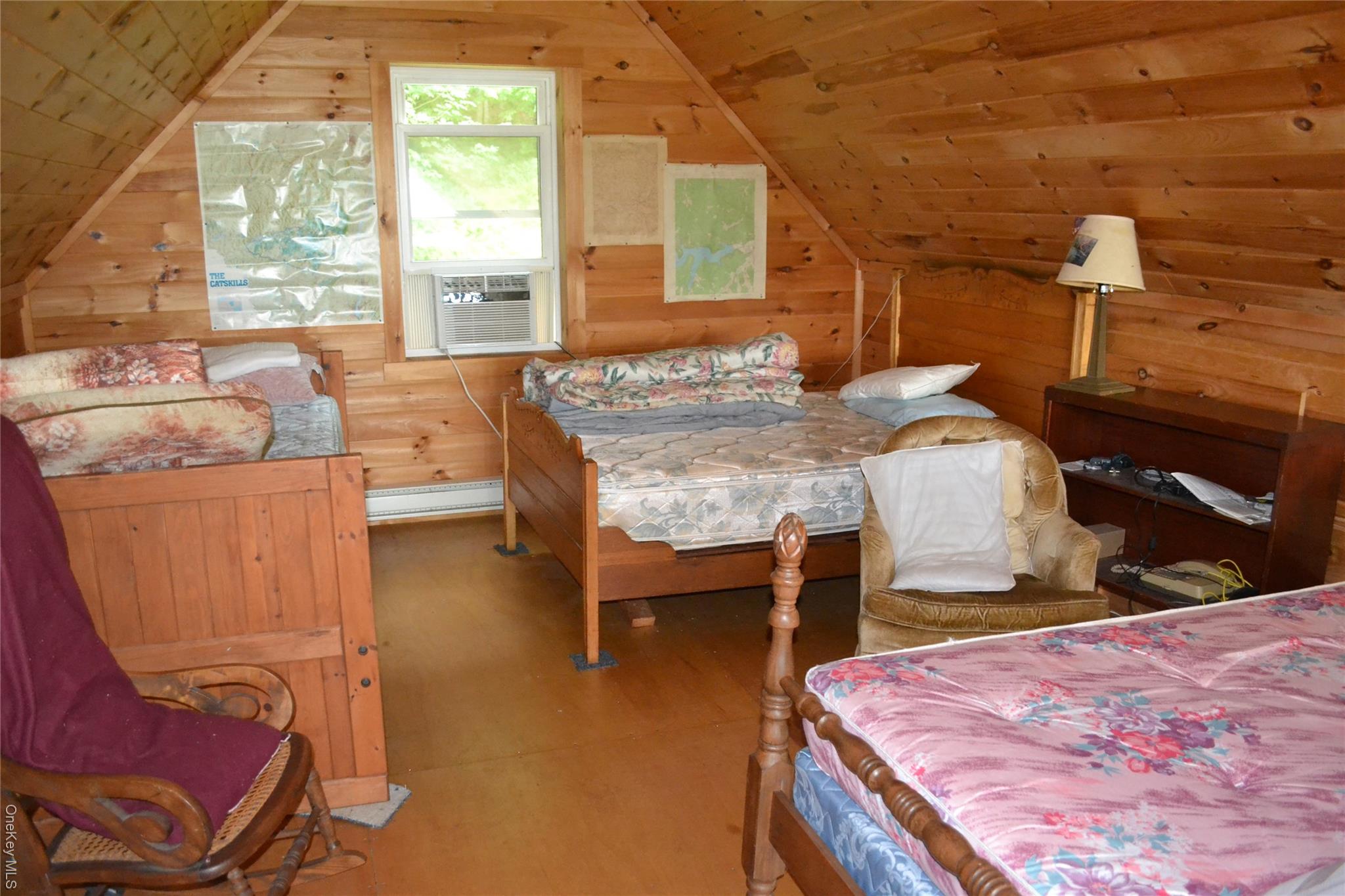 365 Via Appian Way Roscoe, NY 12776 - Photo 19 of 30 Bedroom with wood walls, wood-type flooring, and vaulted ceiling