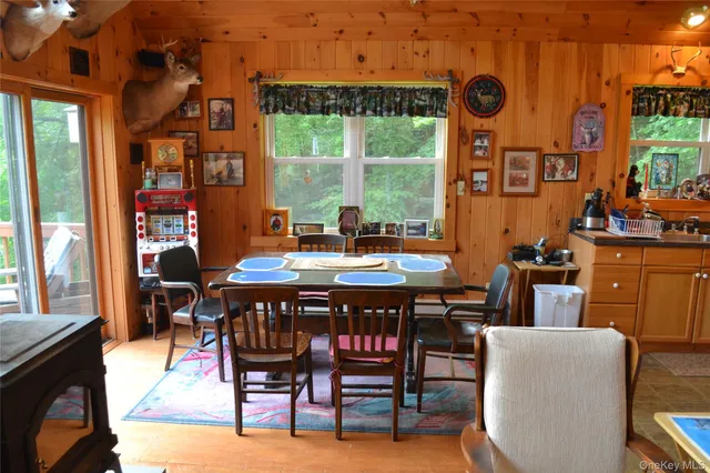 a dining room with furniture and a floor to ceiling window