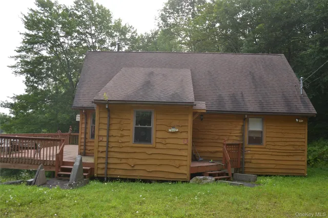 a view of backyard with wooden fence