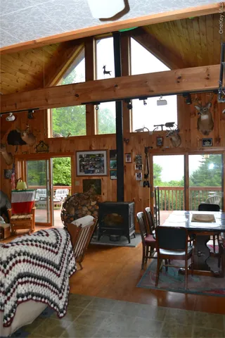 a living room with furniture a floor to ceiling window and a table