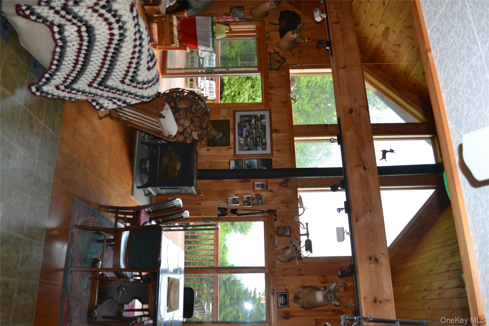 365 Via Appian Way Roscoe, NY 12776 - Photo 10 of 30 a living room with furniture a floor to ceiling window and a table