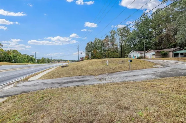 a view of a house with a yard and trees