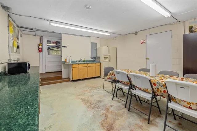 a view of a house with a backyard and trees