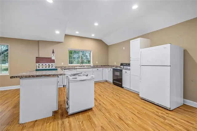 a view of a room with wooden floor