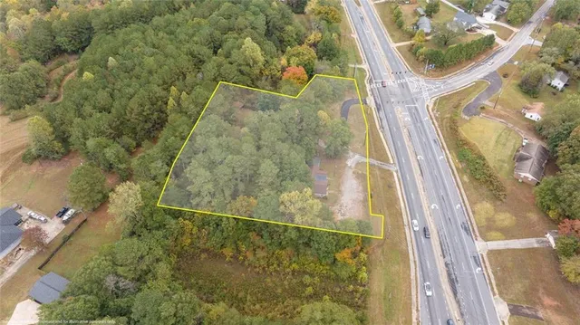 an aerial view of a residential houses with yard