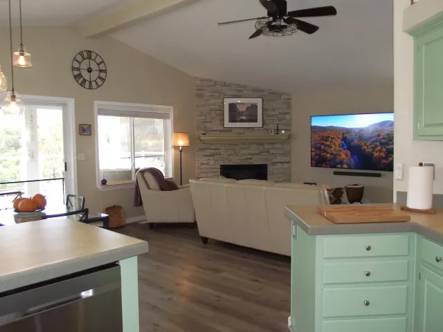 a view of a house with a small yard and wooden fence