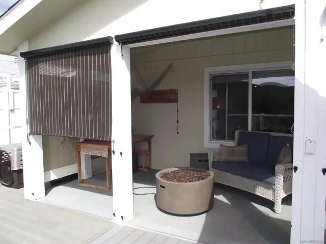 a bedroom with a bed and a chandelier fan