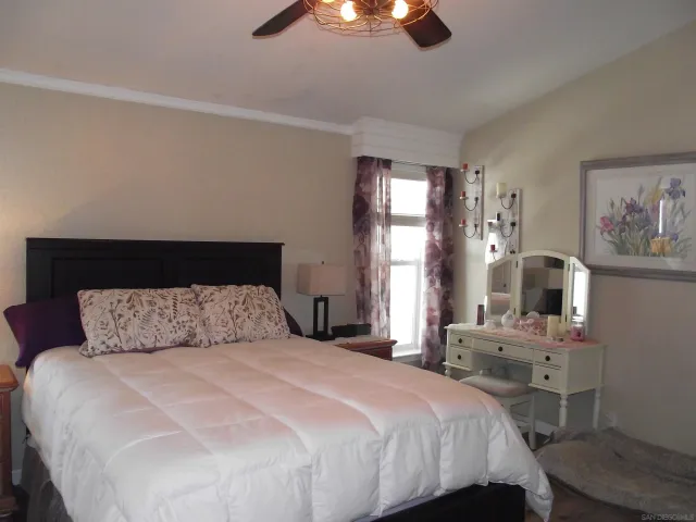 a dining room with furniture a chandelier and wooden floor