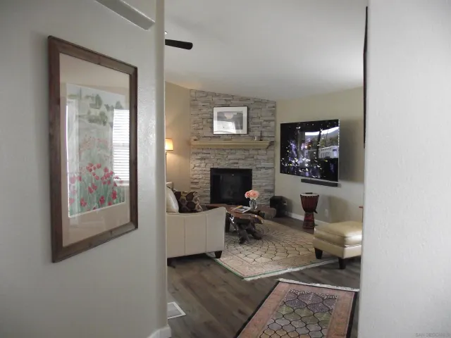 front view of a house with a yard and potted plants