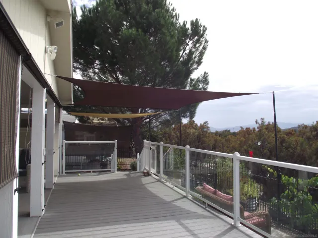 a view of a swimming pool with a yard and sitting space