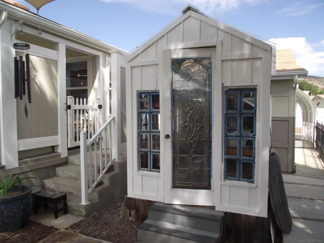 a view of a patio with chairs and a yard