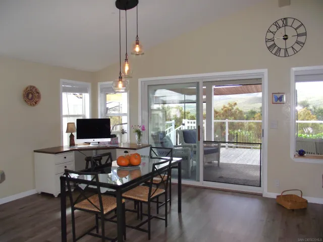 a kitchen with a stove a sink a microwave a dining table and chairs