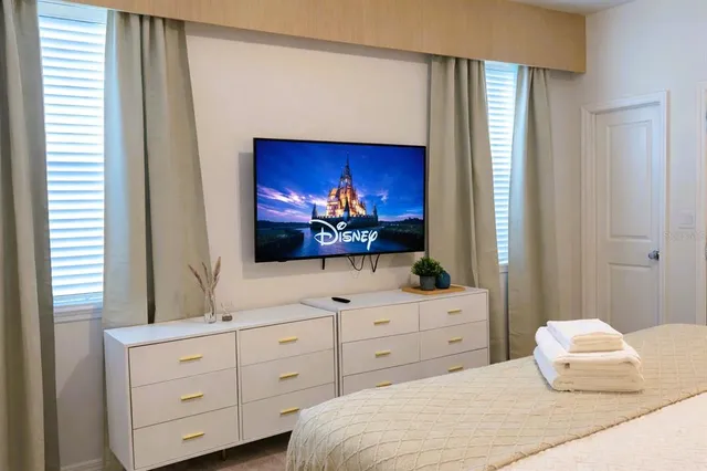 a bedroom with a bed and a painting on the wall