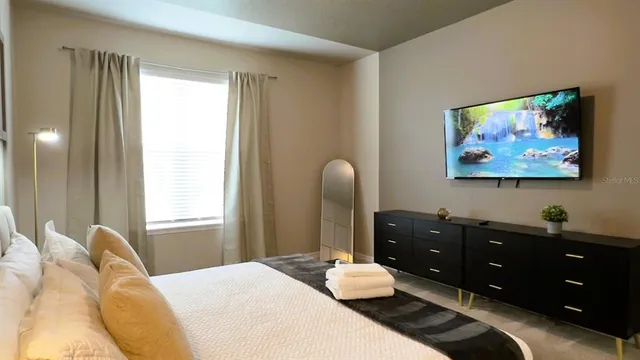 a bathroom with a granite countertop sink a mirror and a picture of a wall