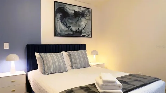 a bedroom with two beds and a flat screen tv