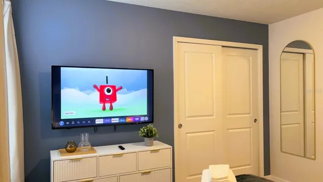 a bedroom with a bed and a dresser