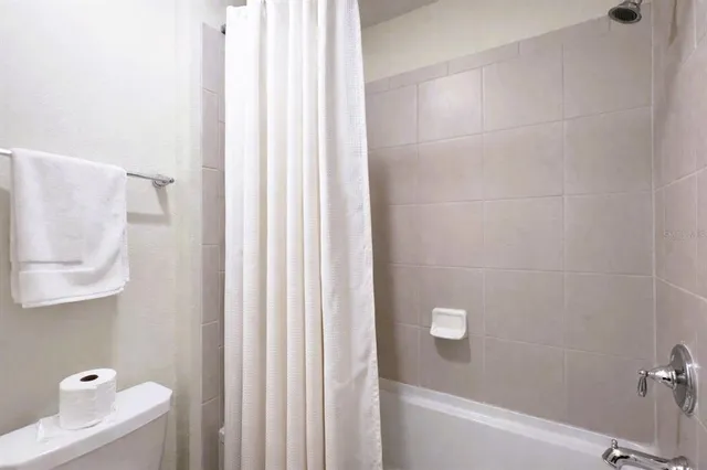 a bedroom with a bed and a dresser in it