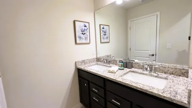 a bedroom with a bed and a night stand