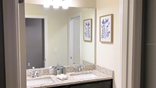 a bedroom with a bed and a night stand