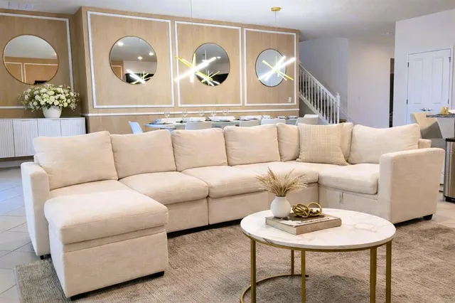 a living room with furniture and a chandelier