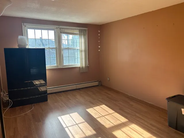 a bench sitting in a room next to a window