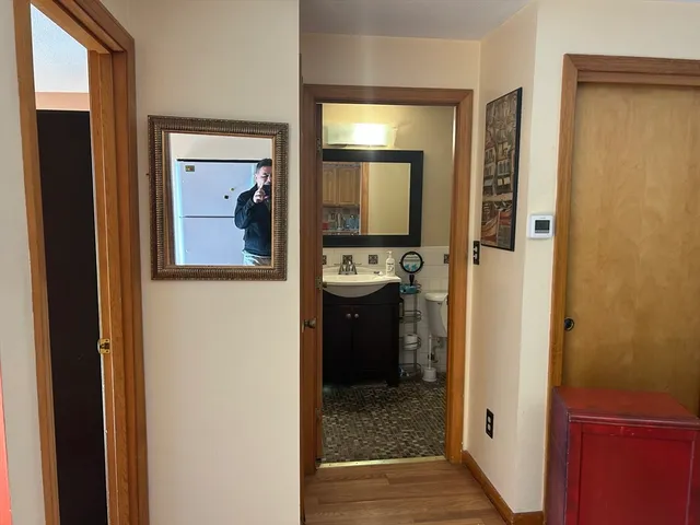 a bathroom with a sink toilet and mirror