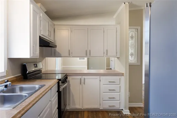 a kitchen with cabinets appliances and a sink