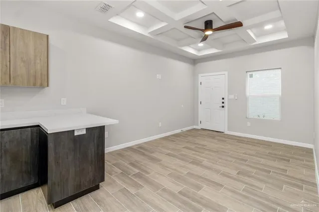 a view of room with wooden floor and ceiling fan