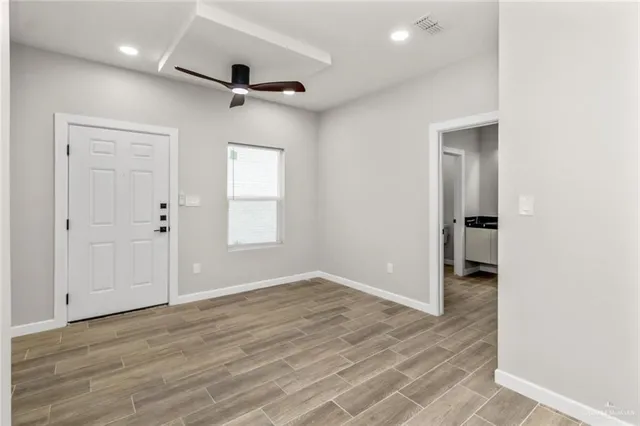 wooden floor in an empty room with a window