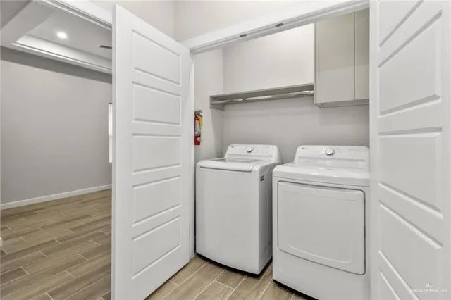 a view of storage and utility room with washer and dryer
