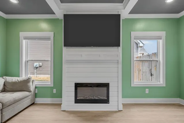 a living room with a fireplace and a window