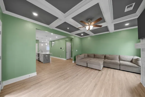 a living room with furniture and a chandelier