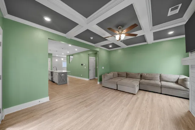 a living room with furniture and a chandelier