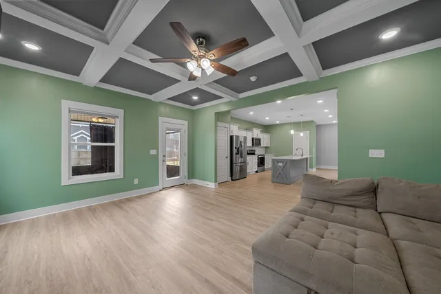 a view of livingroom and a kitchen with wooden floor