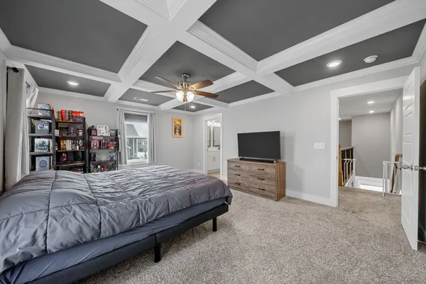 a bedroom with a large bed and a flat screen tv