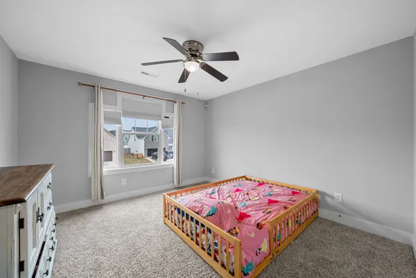 a bedroom with a bed and window