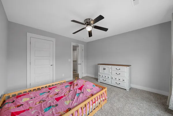 a bedroom with a bed and a dresser