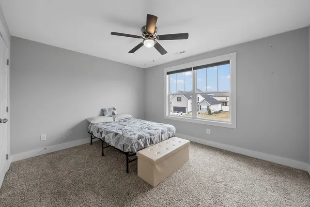 a living room with hard wood floors and a window