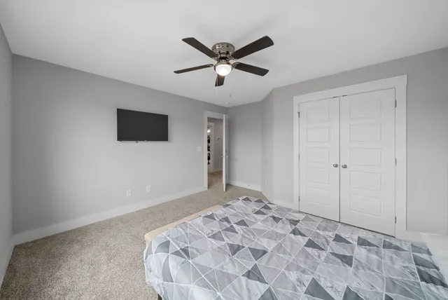 a view of a livingroom with a ceiling fan and wooden floor