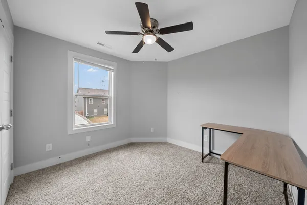 a view of room with window and ceiling fan