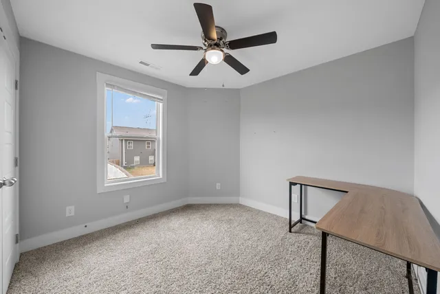 a view of room with window and ceiling fan