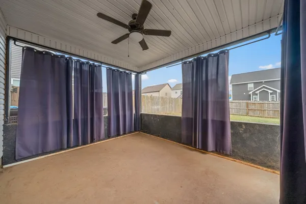 a view of hallway with a ceiling fan