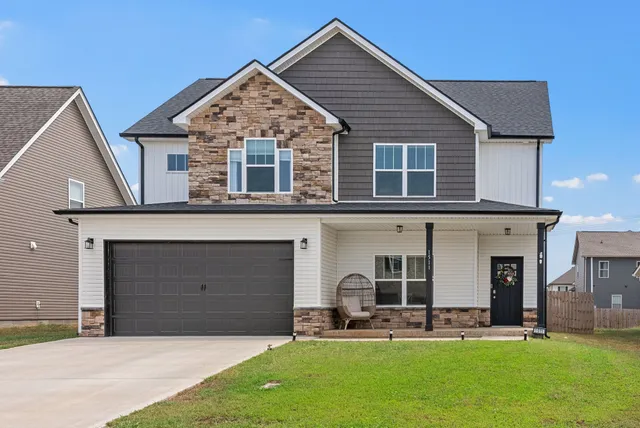 a front view of a house with a yard and garage