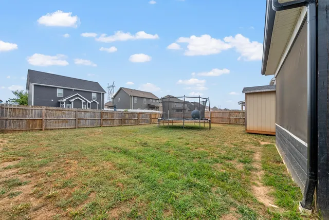 a house view with swimming pool and yard