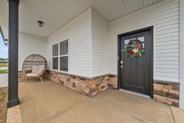 a backyard of a house with table and sofas
